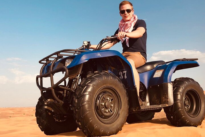 Experience the thrill of riding across stunning desert dunes on a quad bike capturing unforgettable moments while enjoying a mix of adventure and culture in Dubai's breathtaking landscape.